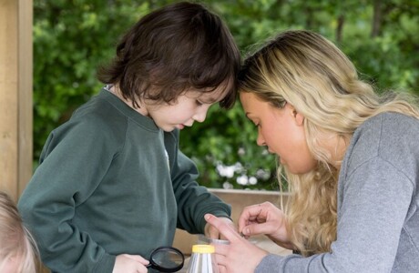 Reception teacher outdoors min